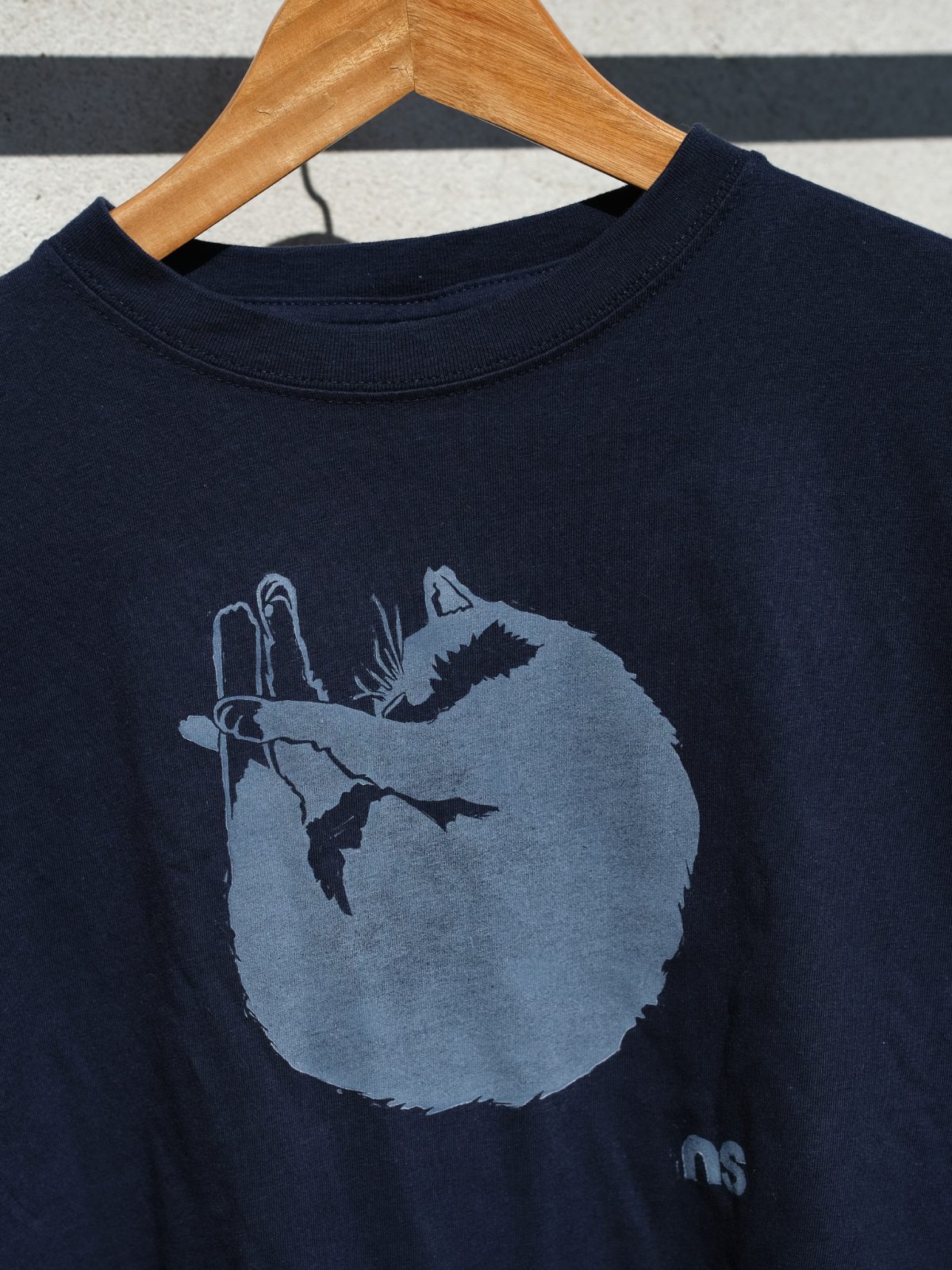 Close-up of the linocut print on a dark T-shirt