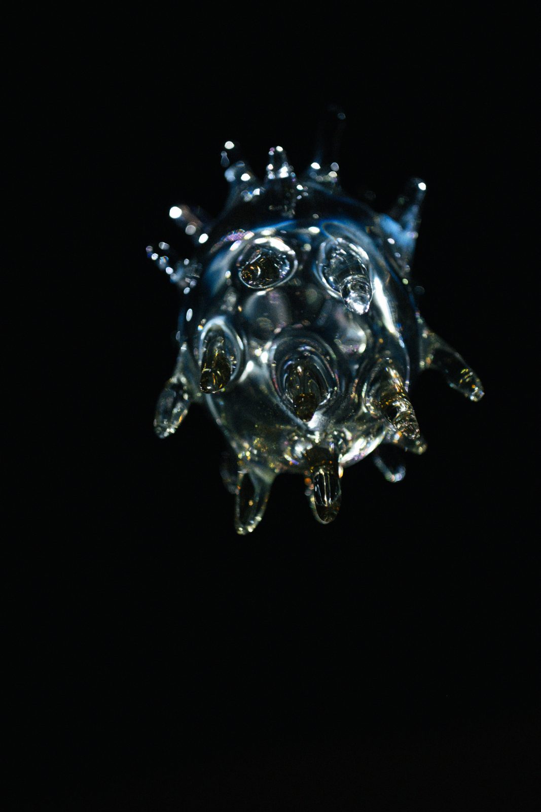 A glass crystal sculpture on a black background