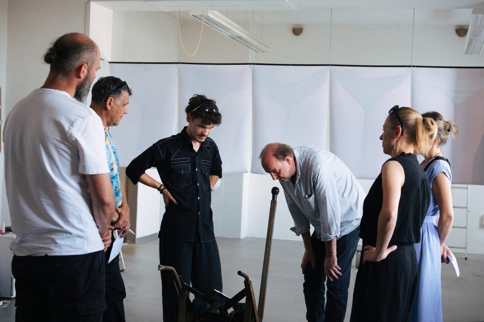 Visitors gathered around an installation in a white gallery room