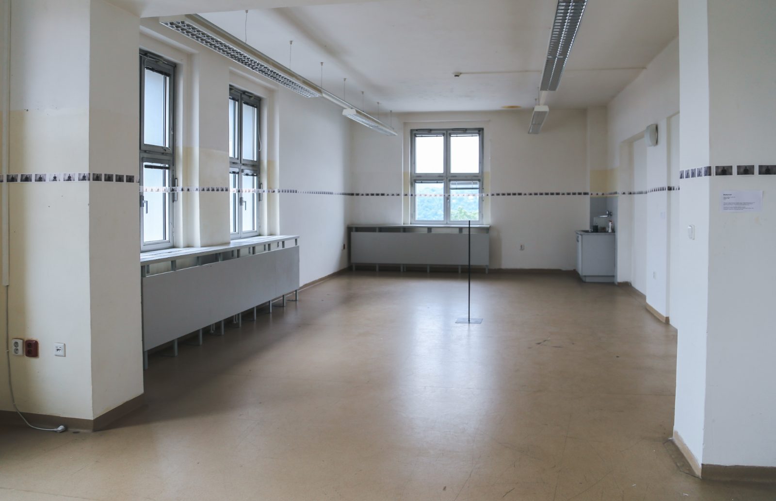The gallery room with the band of photographs circling its walls