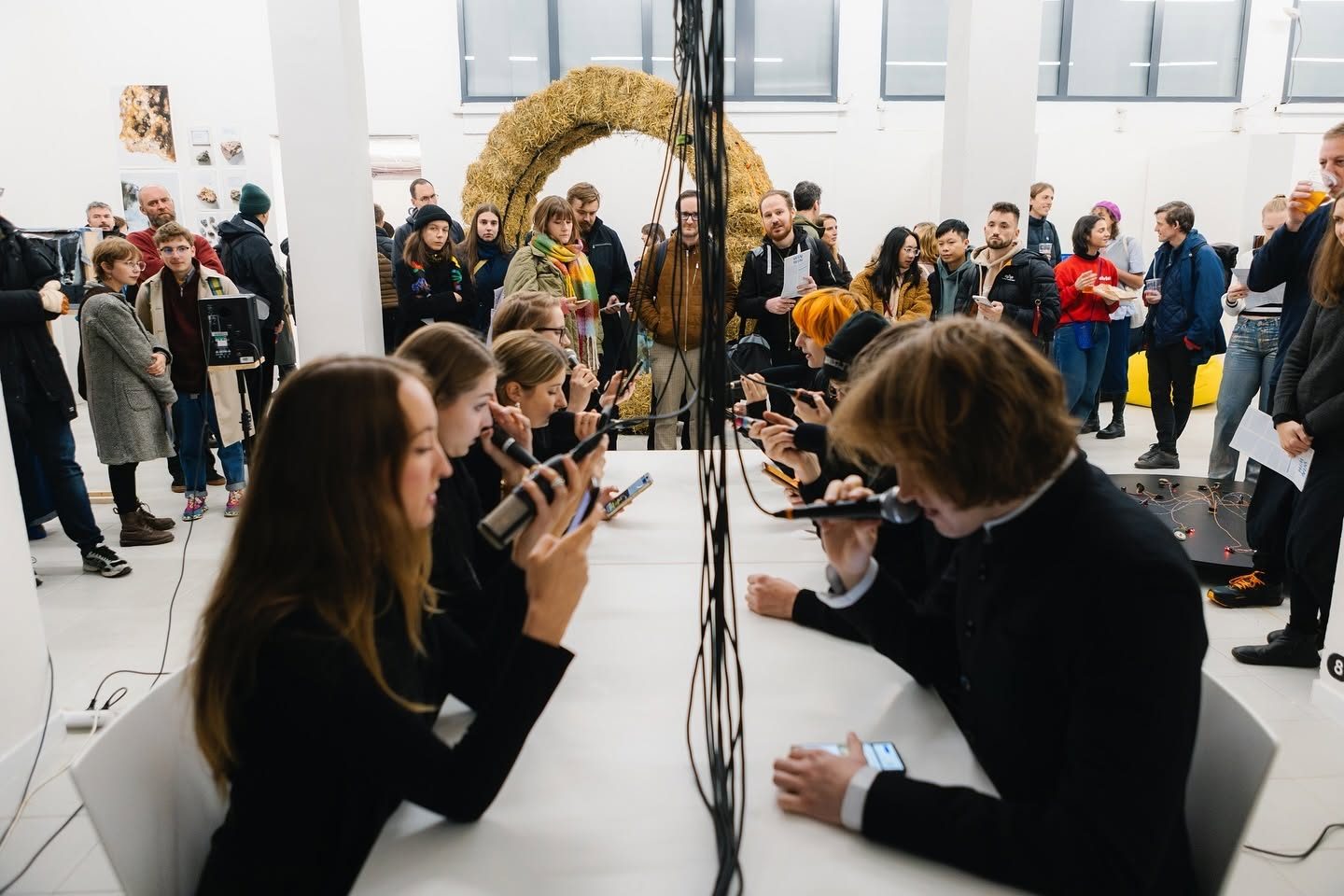 Crowd of visitors surrounding the performers at the table